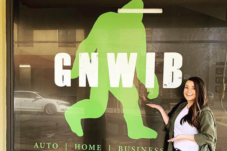 GNWIB - Employee Outside Poitning to the Sign GNWIB - Employee Outside Poitning to the Sign